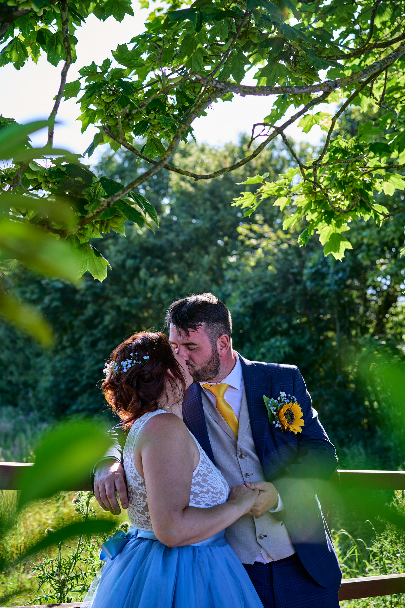 a couple kiss under the trees outside The Aviary Ormskirk
