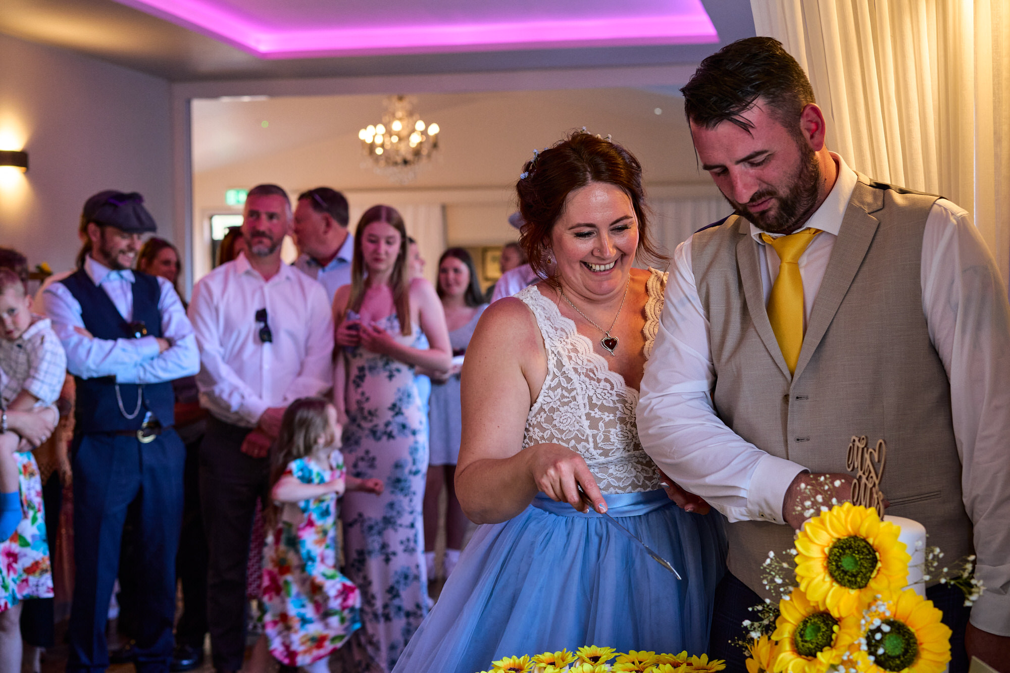 the couple cut their sunflower wedding cakes at The Aviary Ormskirk