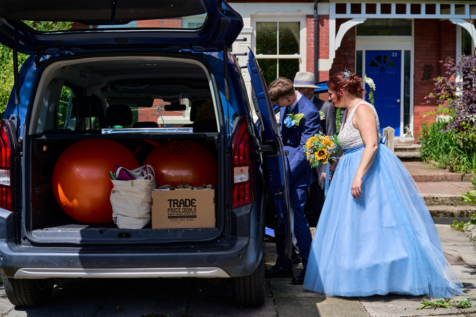 a candid moment on a wedding morning packing the car