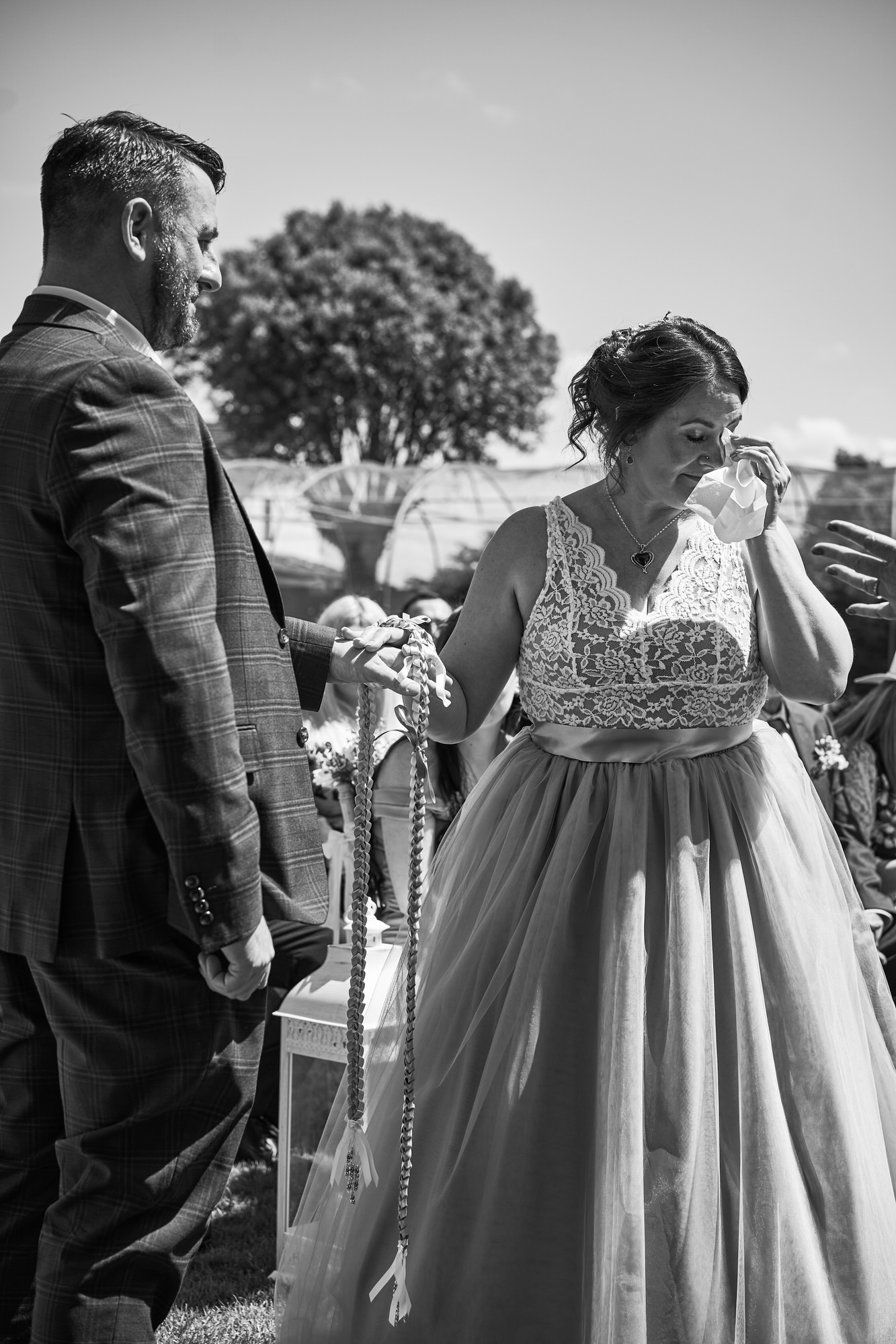 a bride gets emotional during vows and wipes a tear