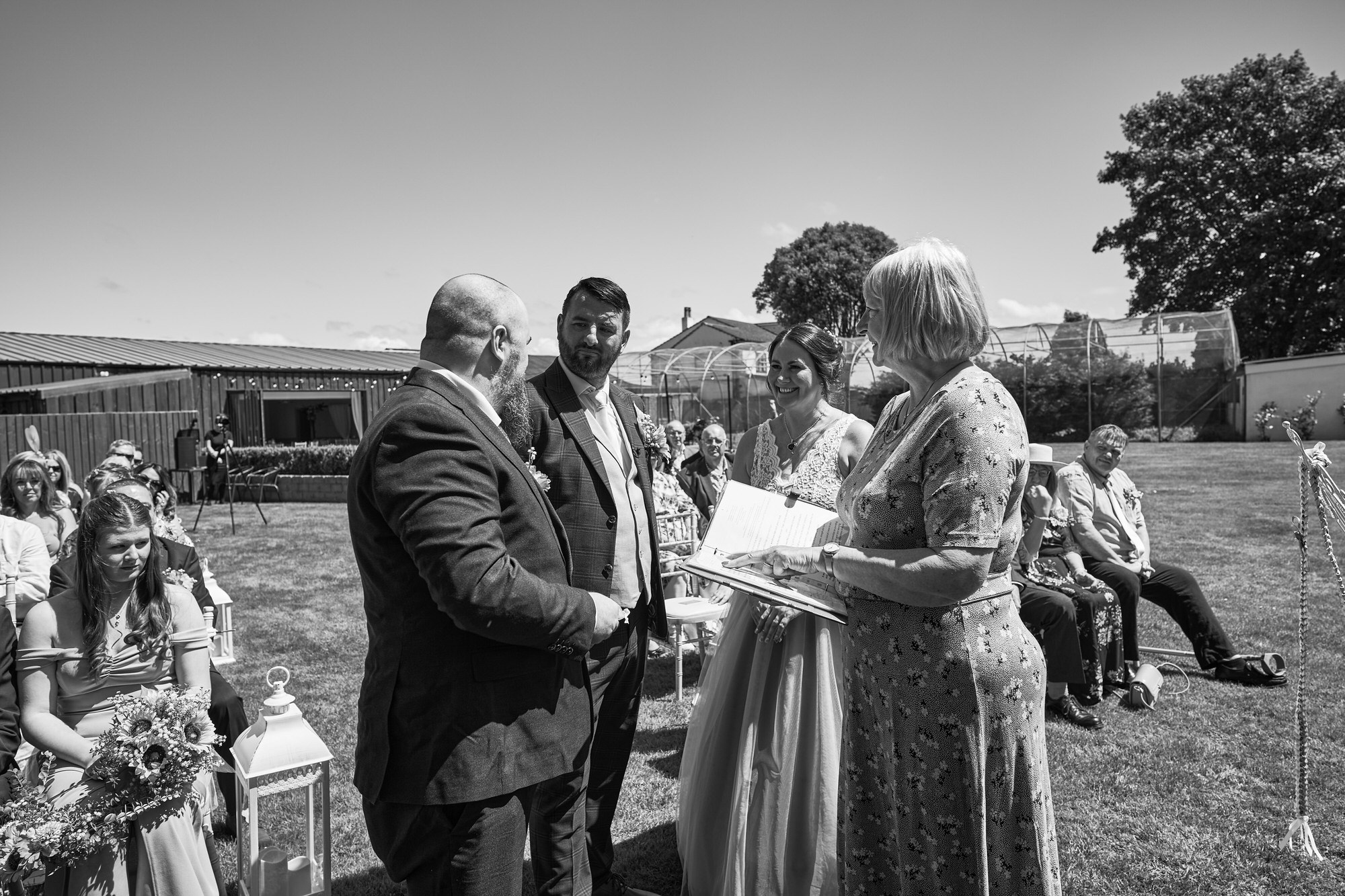 the best man hands over the rings during outdoor ceremony The Aviary Ormskirk