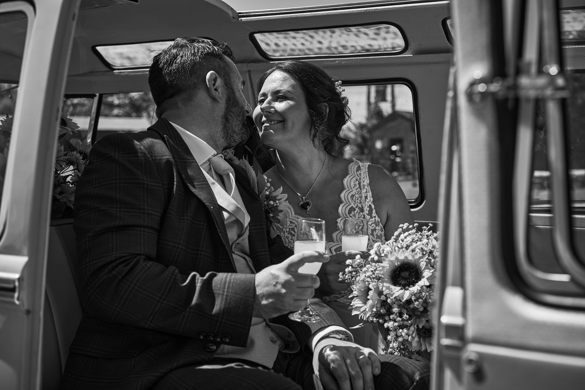 a coupe smile at each other for photos in the campervan