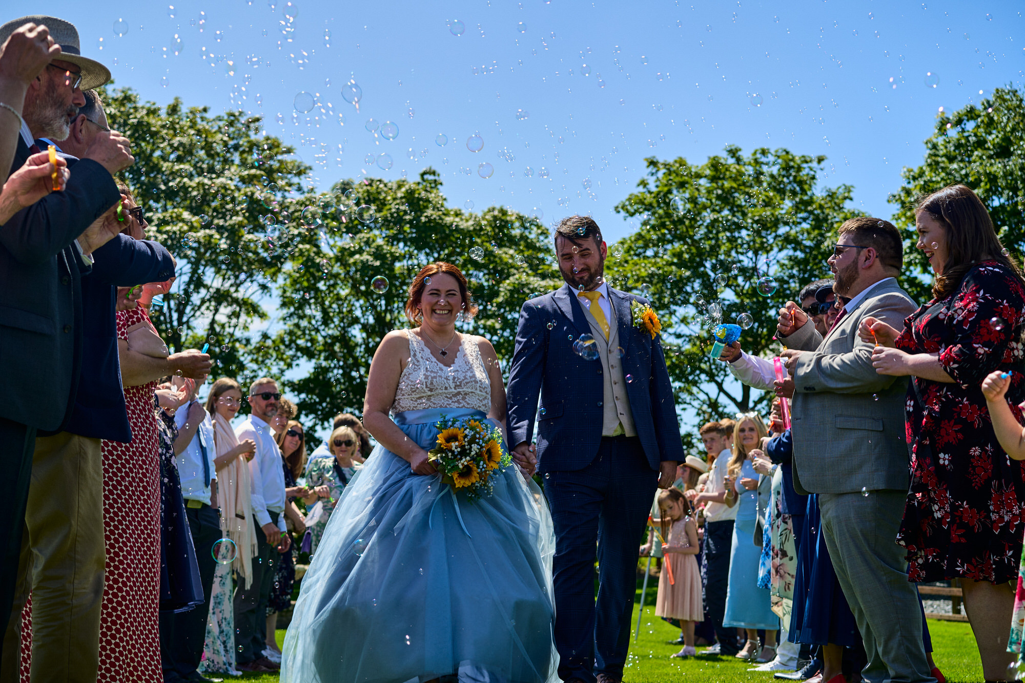 a fun photo of a bubble run at a wedding at The Aviary Ormskirk