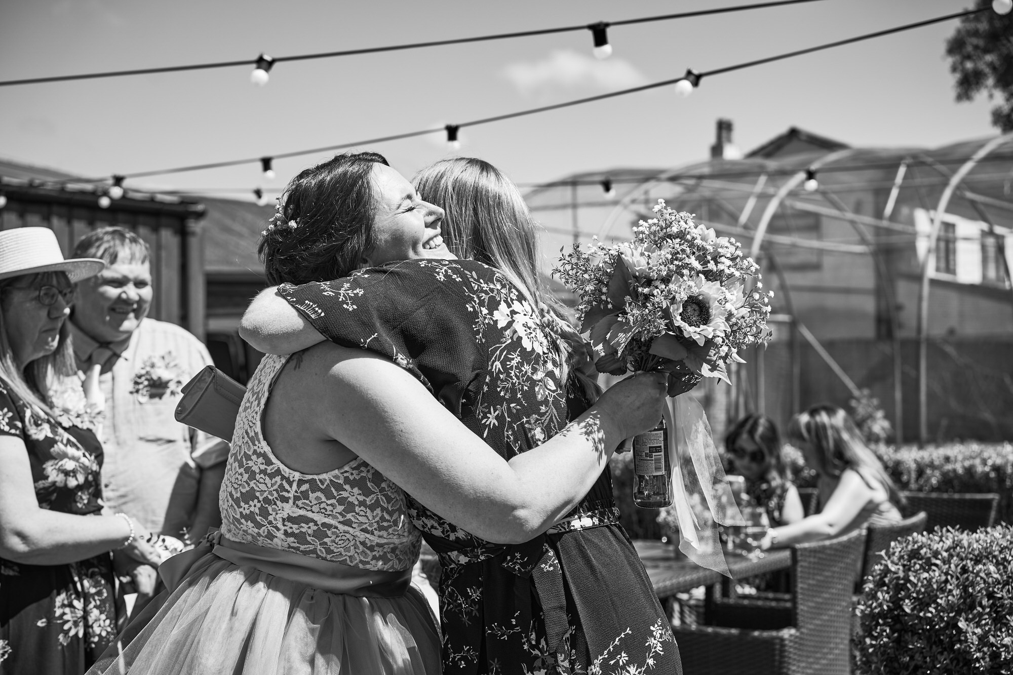 wedding guests hug the bride at The Aviary Ormskirk