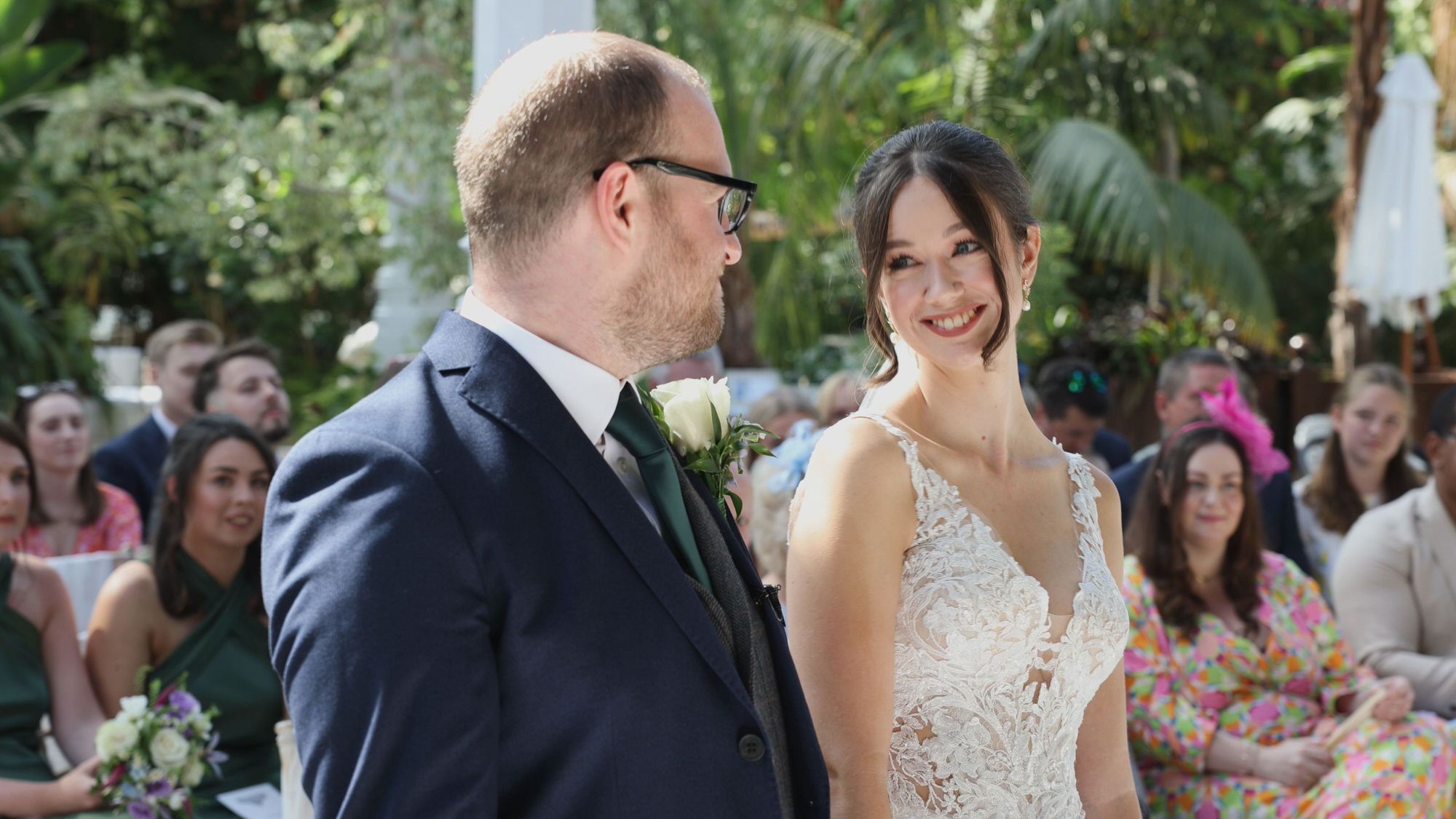 videographer captures a natural smile from the couple during a Sefton Park Palm House wedding ceremony