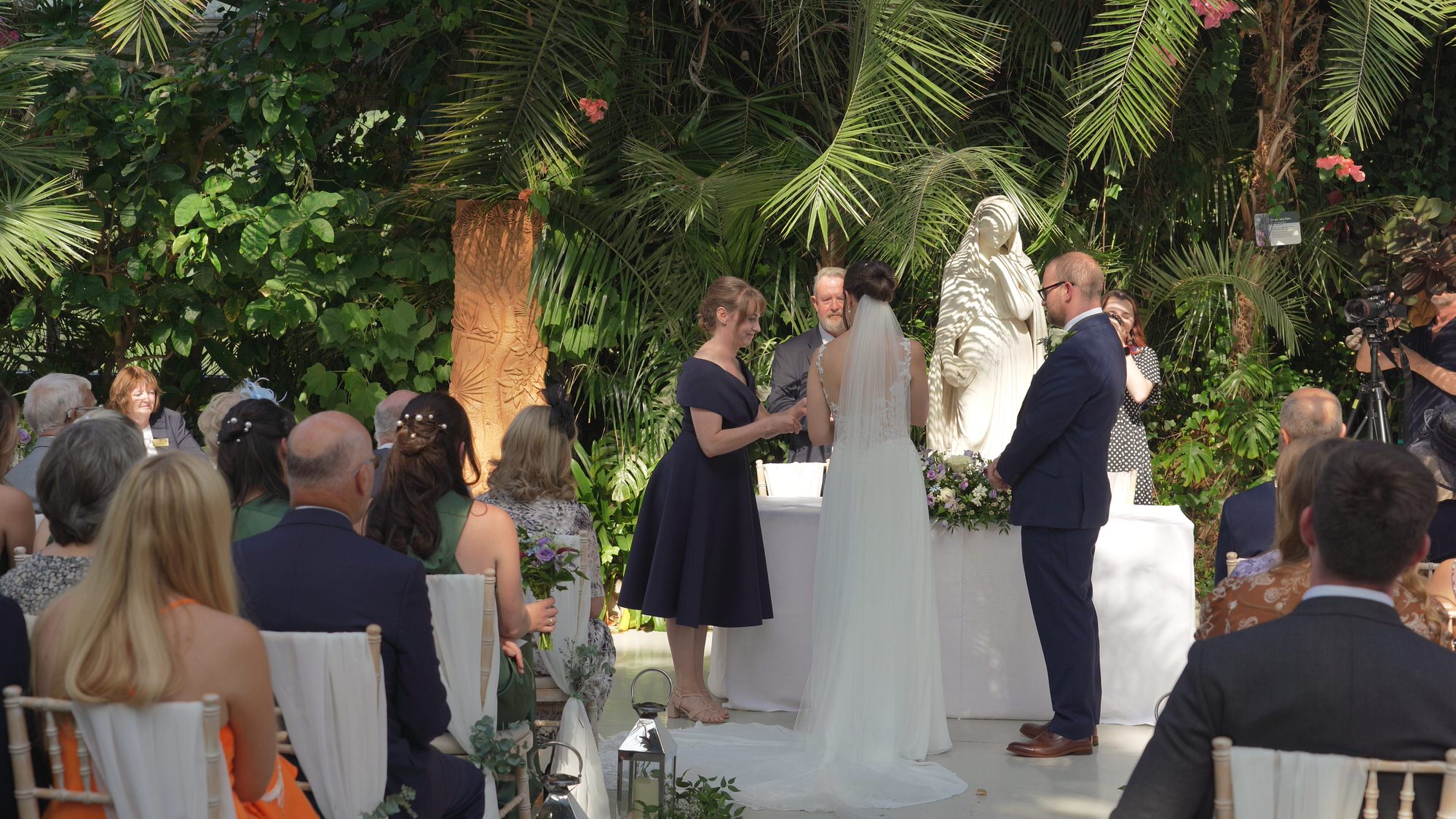 a grooms maid hands over the wedding ring during ceremony