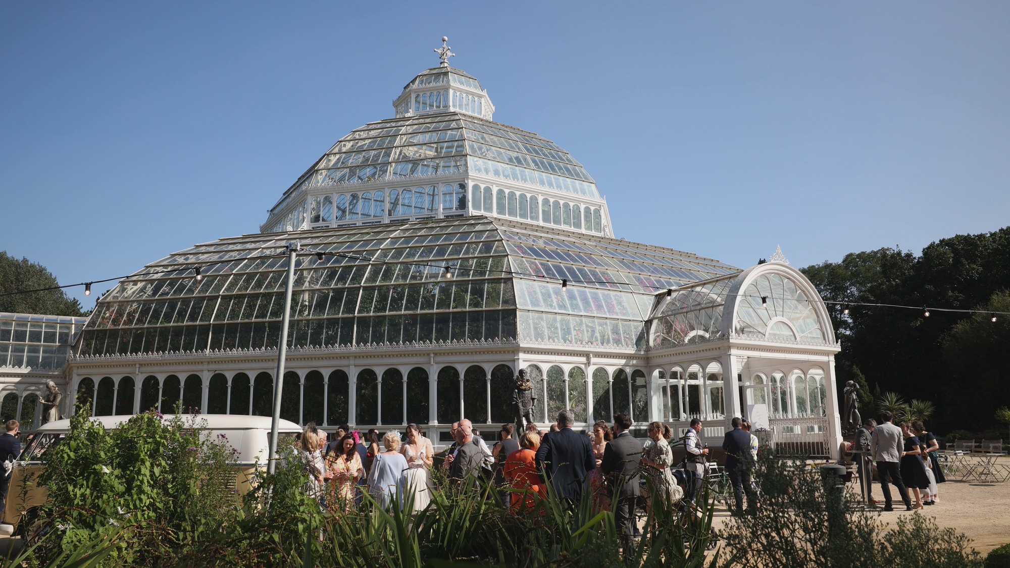a video still of a summer wedding reception outside Sefton Park Palm House Liverpool