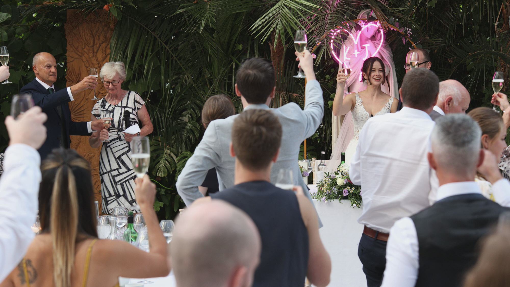 a wide shot of wedding toasts at Sefton Park Palm House Liverpool