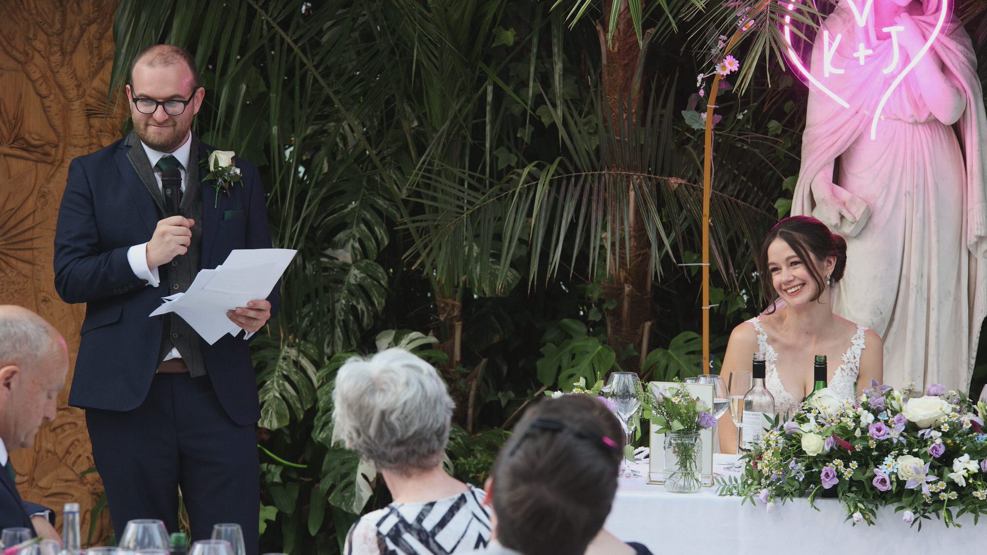 the groom stands to give his speech at Sefton Park Palm House Liverpool