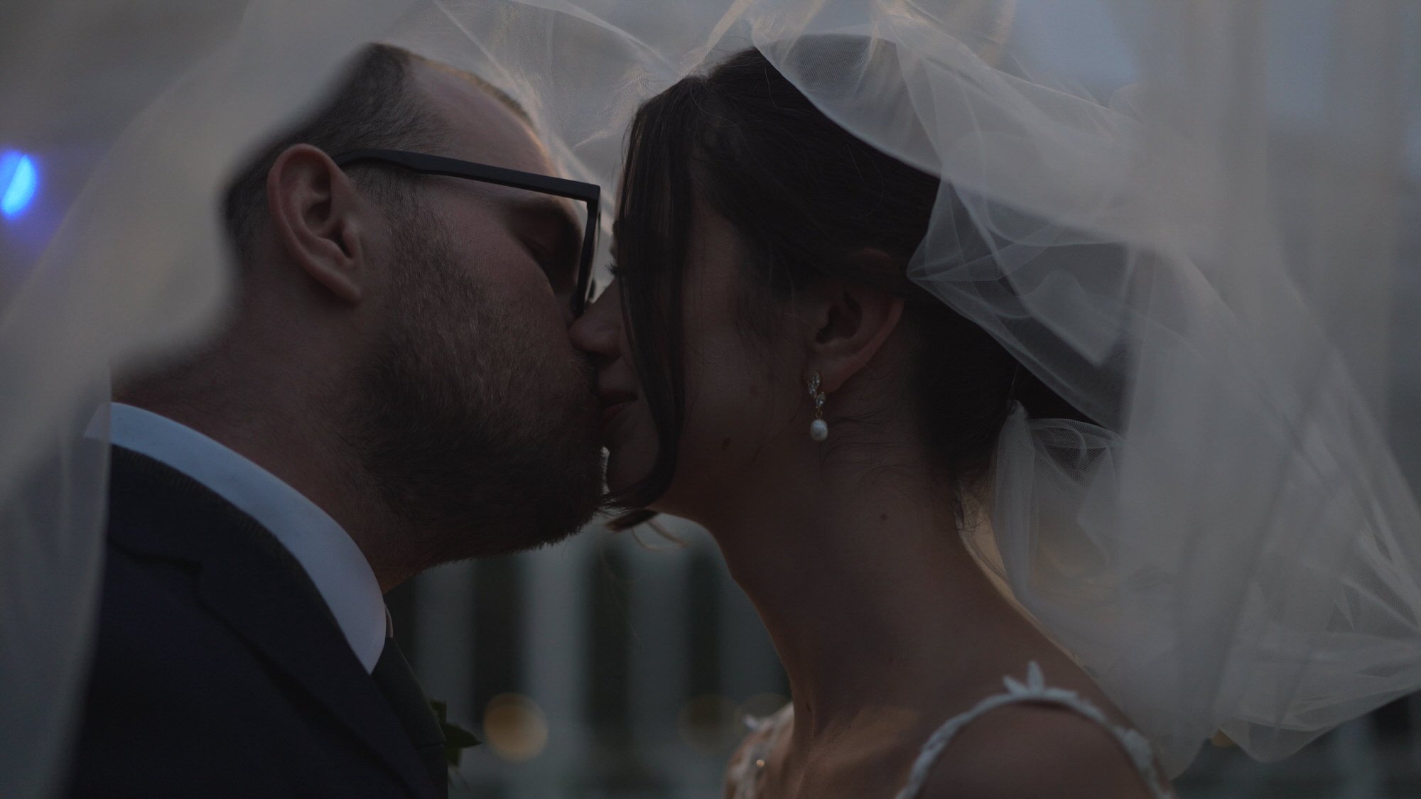 a romantic moment under her wedding veil outside the Palm House