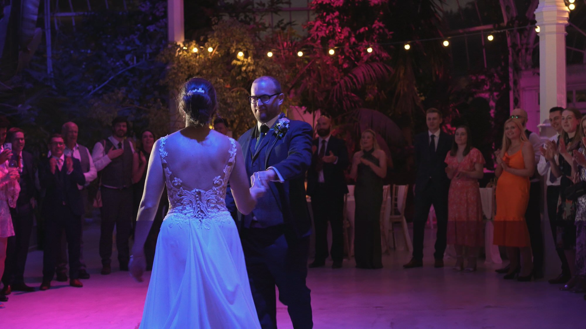 a bride and groom surprise guests with a choreographed first dance