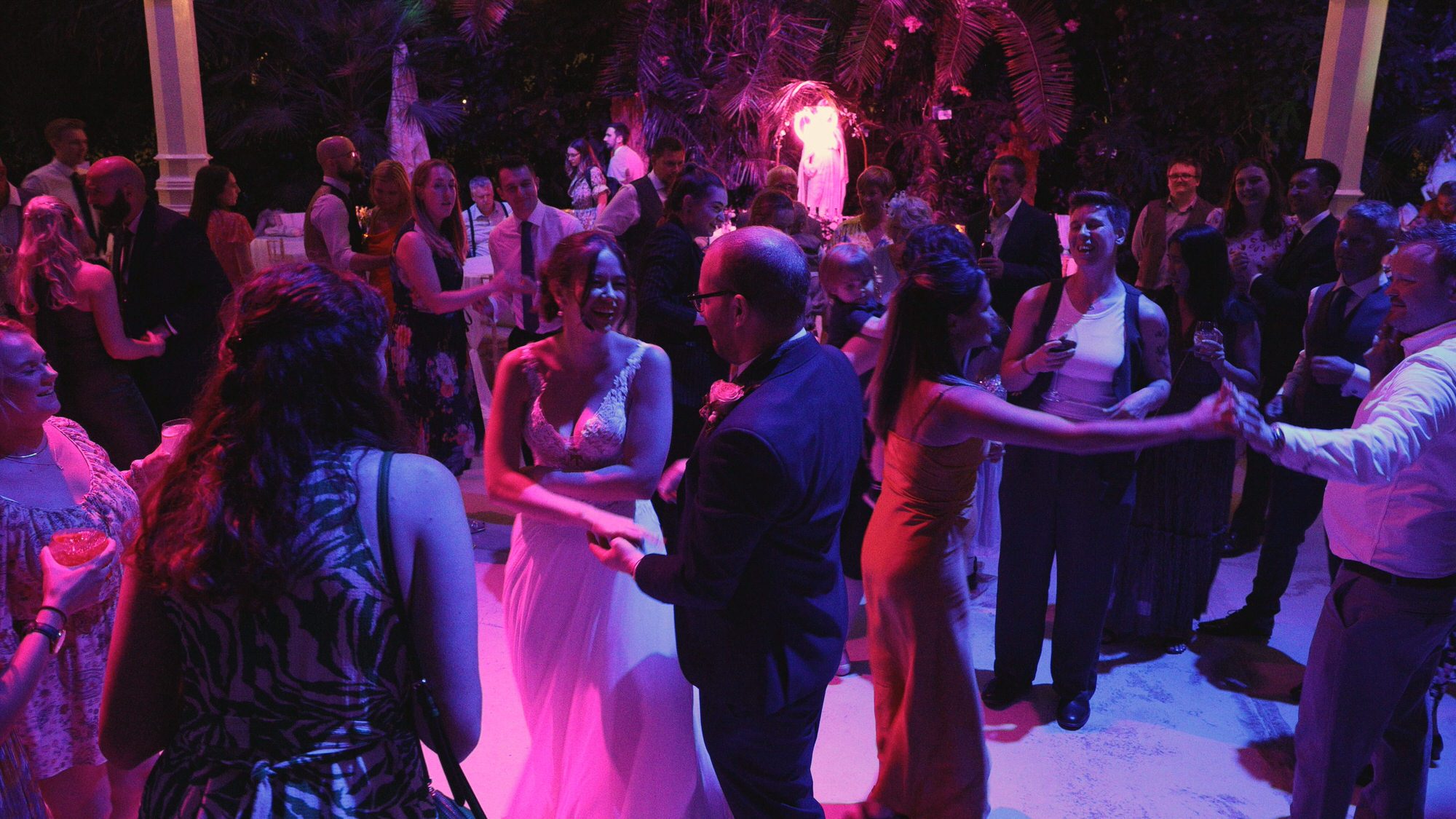 guests dance with the couple during wedding at Sefton Park Palm House Liverpool