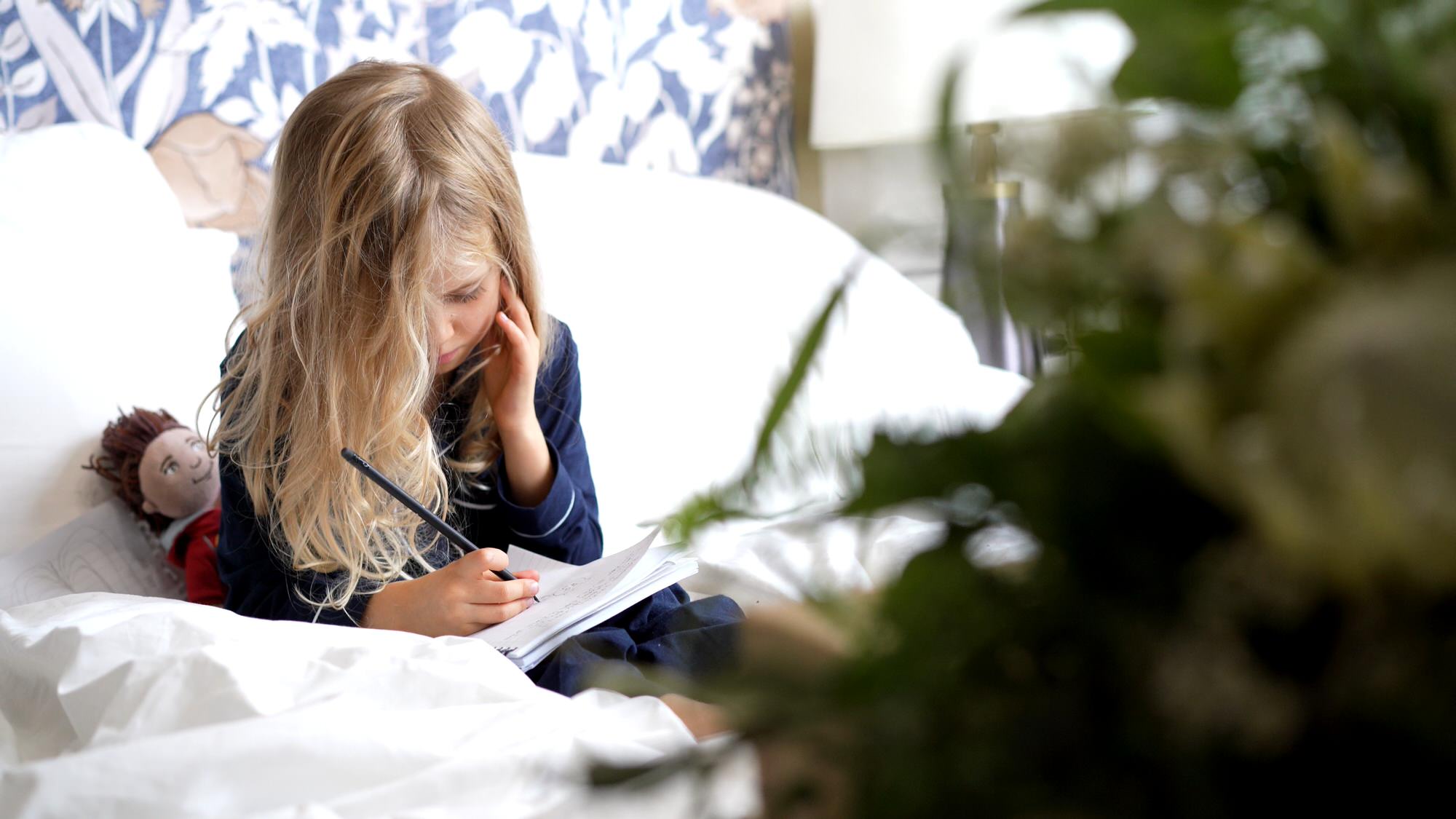 flower girl sits and draws during the wedding morning at Municipal hotel