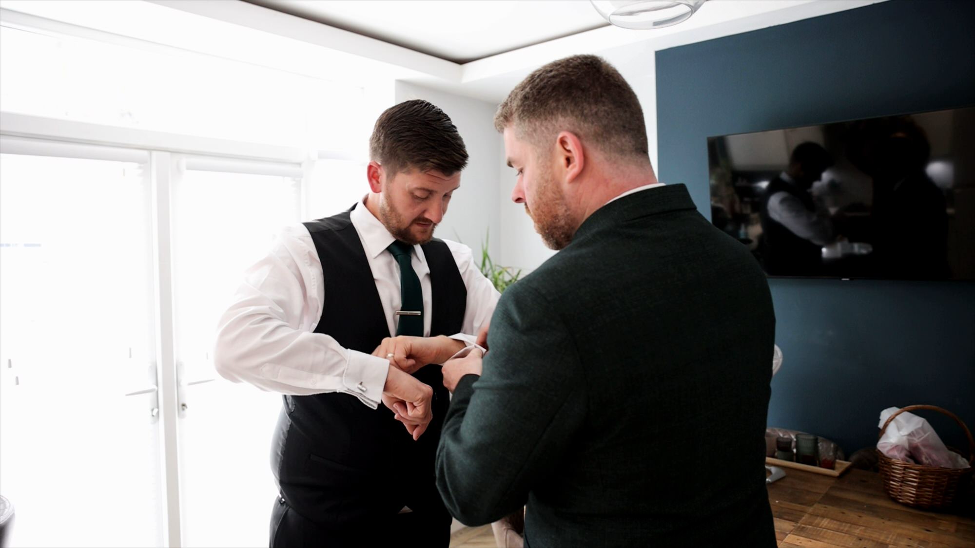 groom helps the best man with his wedding cufflinks