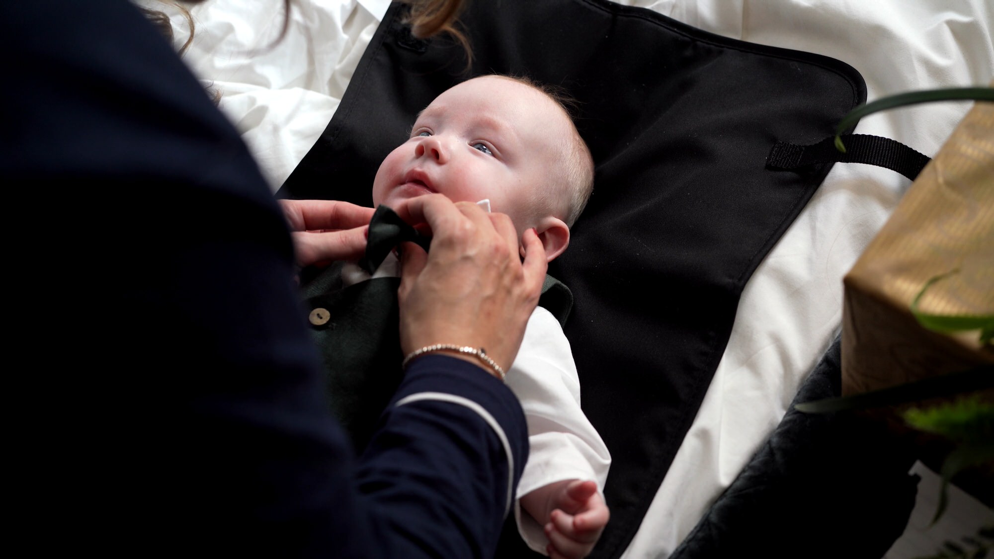 a little baby gets his wedding bow tie and suit fitted in Liverpool