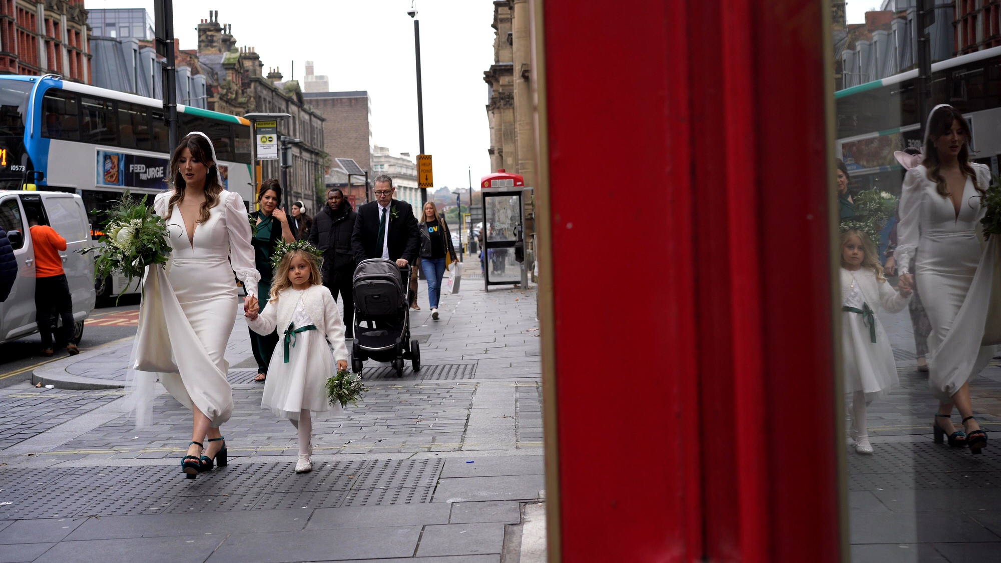 a videographer films a bride walking down dale street Liverpool