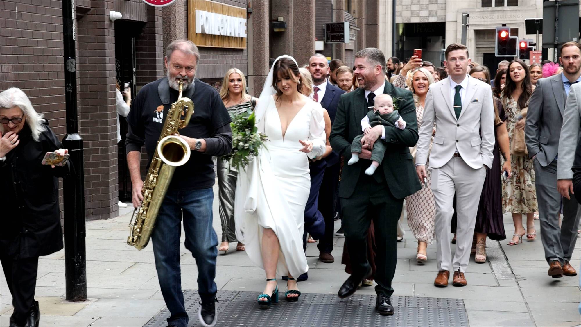 a fun video still of a couple dancing along to walking band