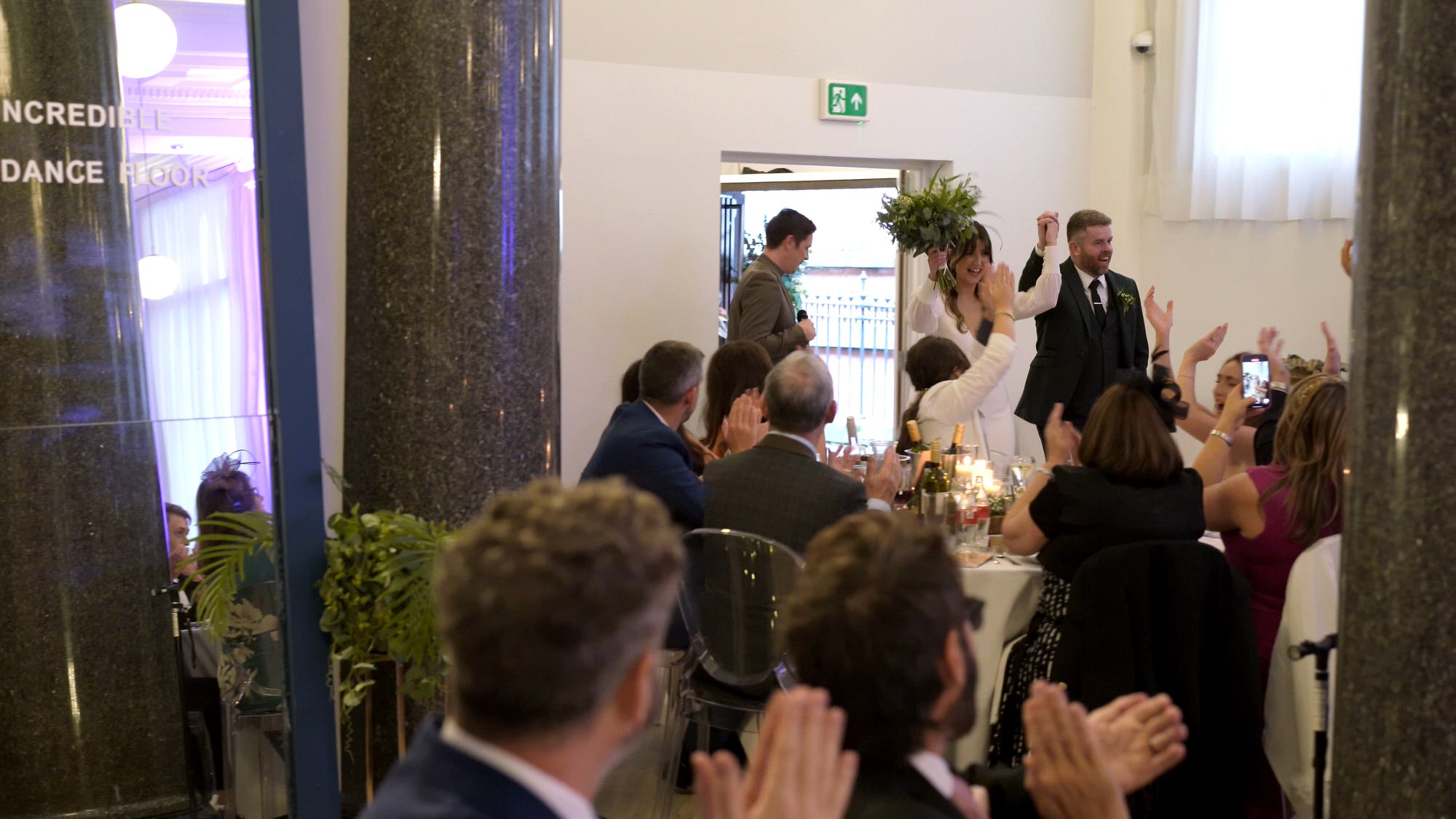 videographer films the couple being announced in to their wedding reception at One Fine Day