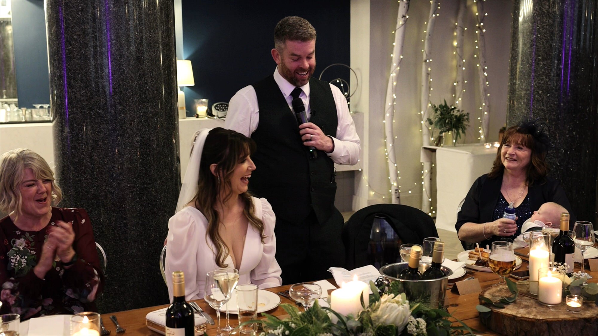 Groom makes the top table belly laugh during wedding