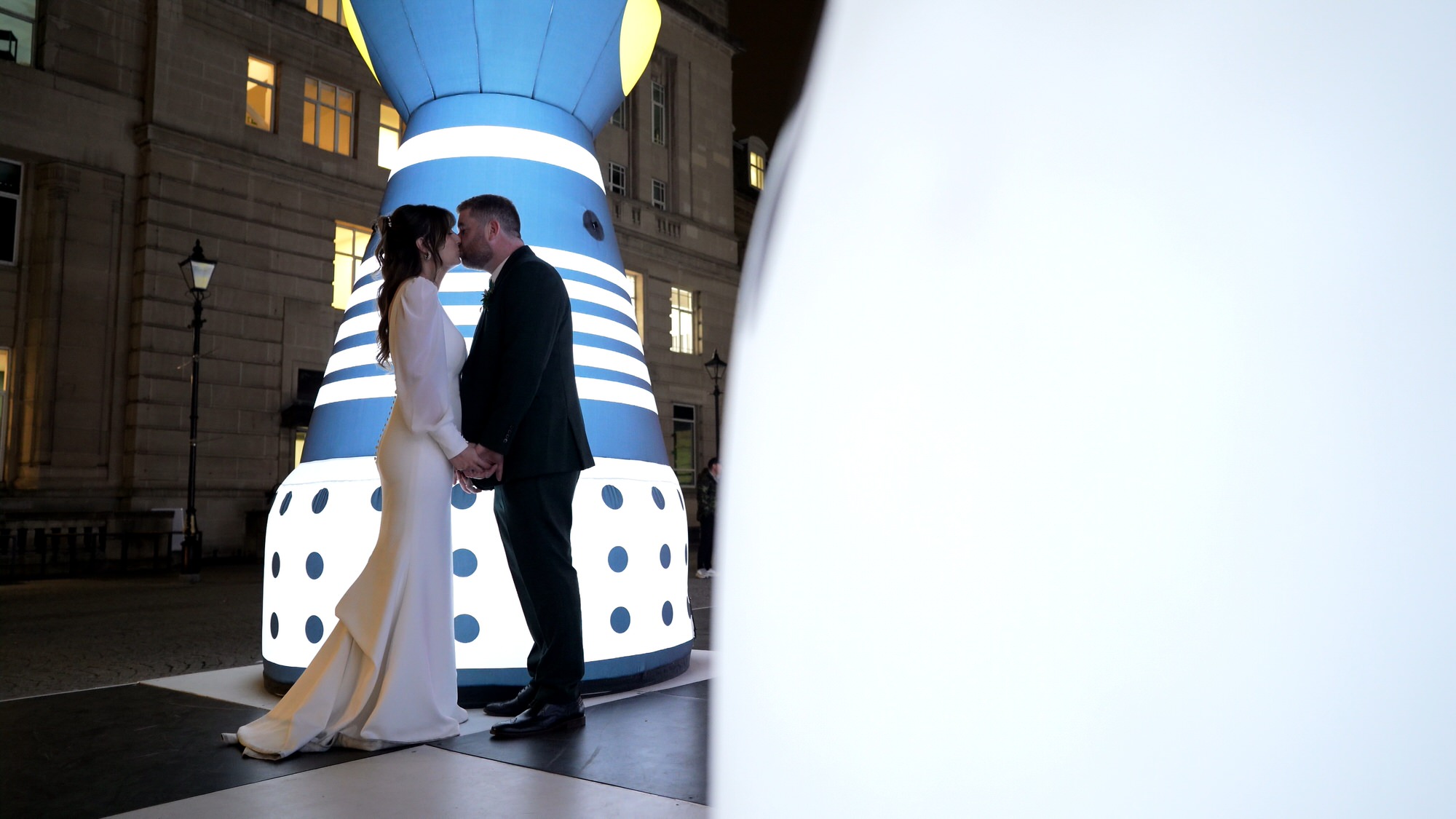 couple pose by chess art installation for River of Light Festival in Liverpool