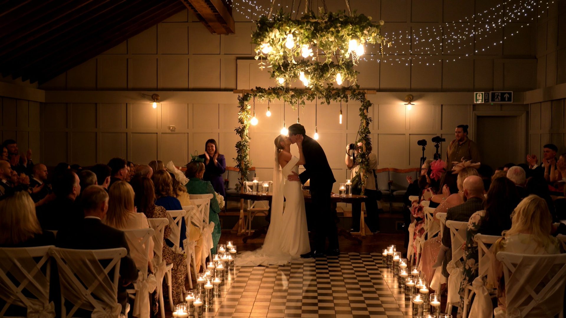 the couple kiss during their black tie wedding ceremony at Larkspur Lodge