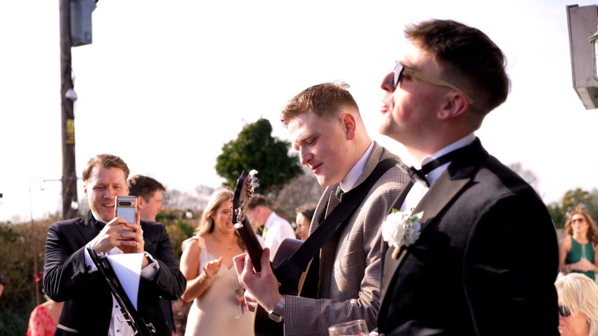 guests sing along with the acoustic singer during wedding reception at Larkspur Lodge