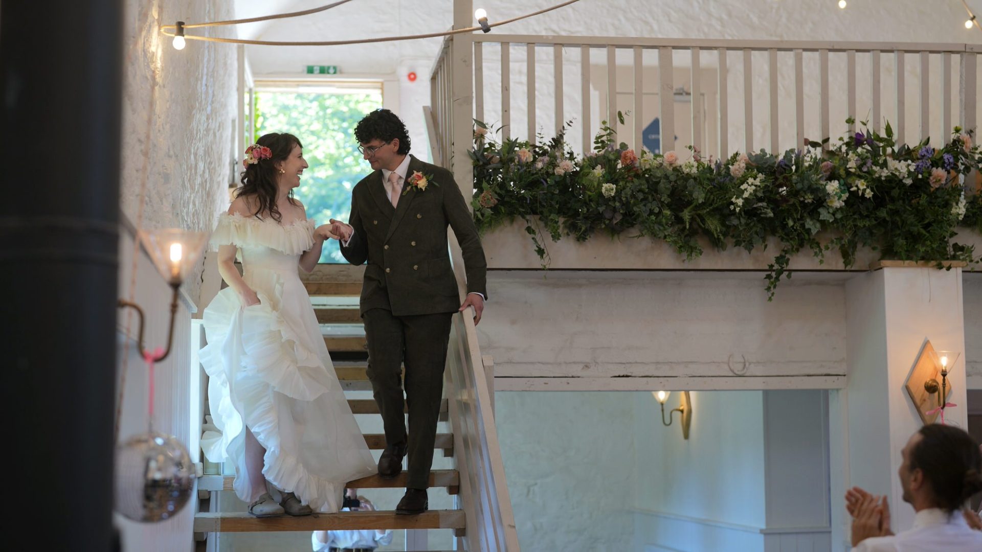 a couple laugh as their announced into the white barn at Wyresdale Park