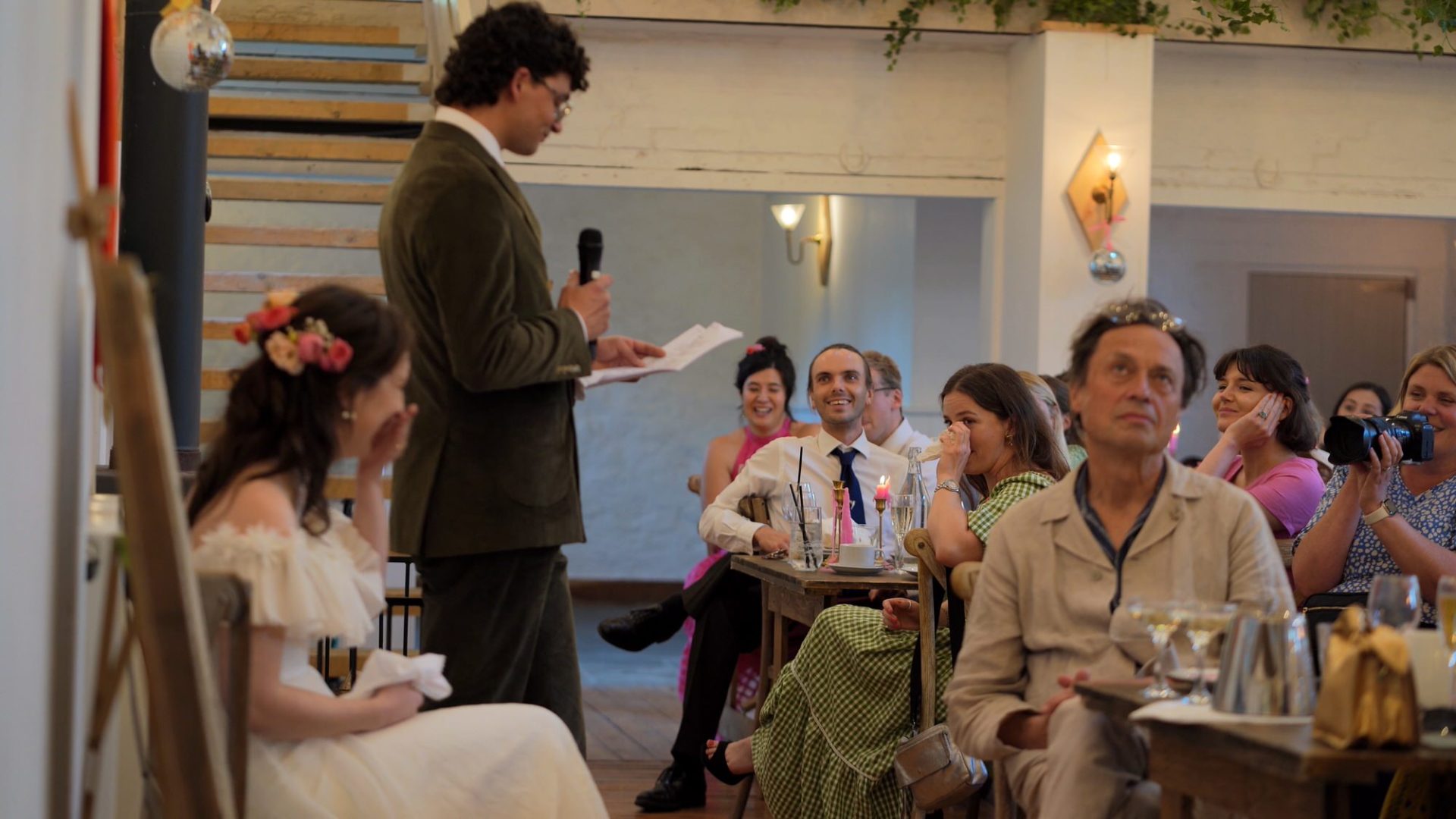 guests laugh during the grooms speech