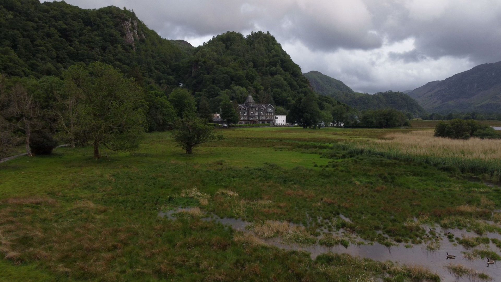 A drone shot of lodore falls hotel from the lake jetty