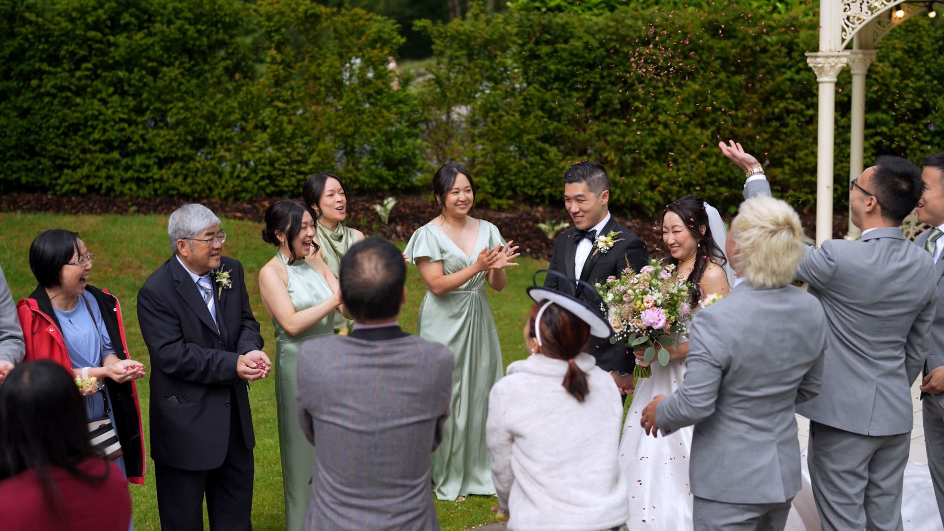 guests cheer and thrown petal confetti