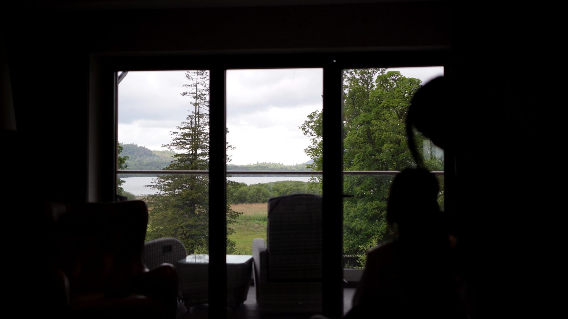 a video still of a bride silhouette getting ready with the view from a lodore falls hotel suite