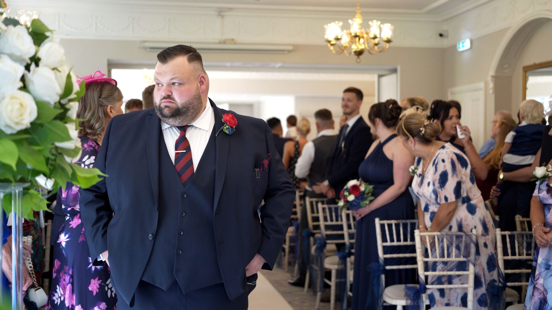 a video still of a nervous groom taking a deep breath before the wedding ceremony
