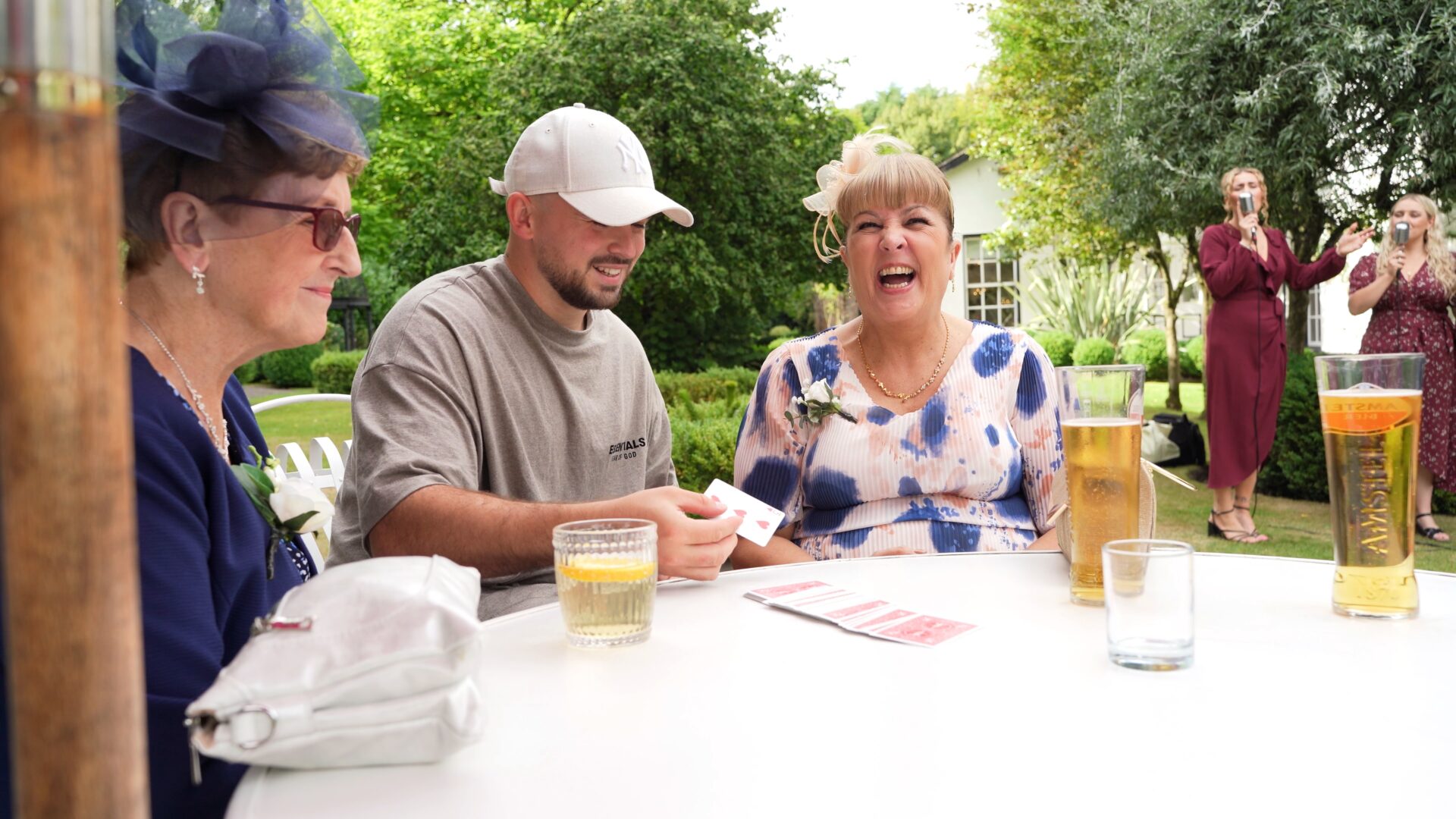 guests react to a magic card trick at Statham Lodge Hotel in Cheshire