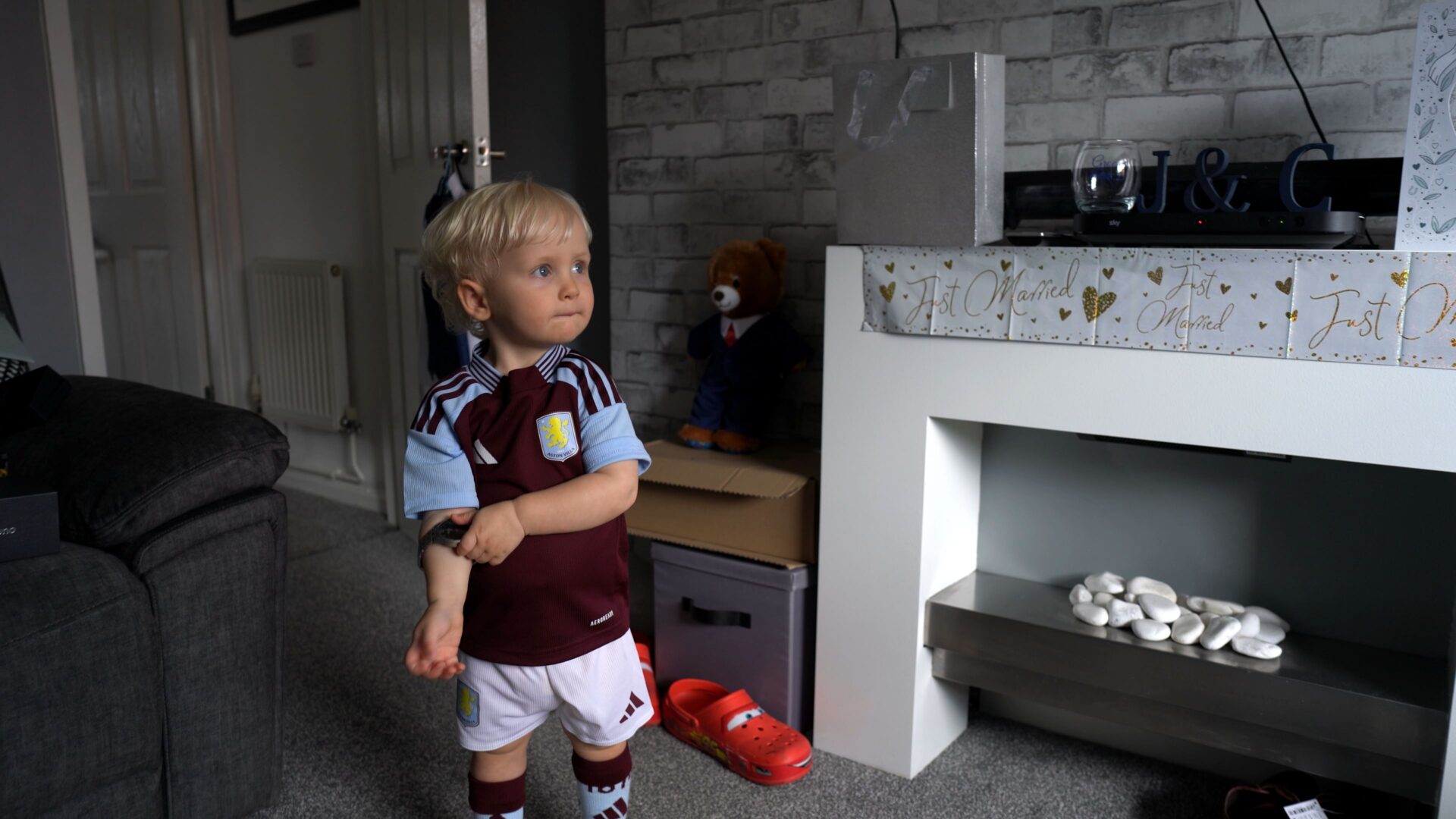 a video still of a young page boy in an aston villa football kit