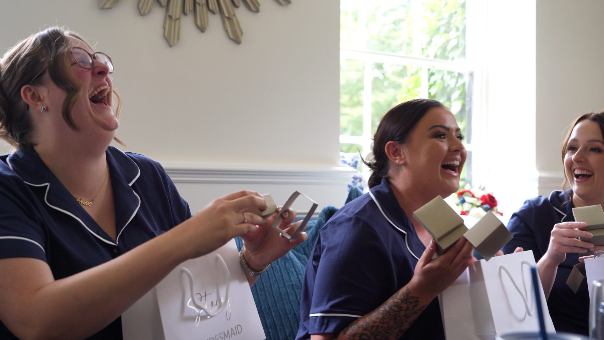 a fun video still of bridesmaids in matching PJs laughing Statham Lodge Hotel in Cheshire