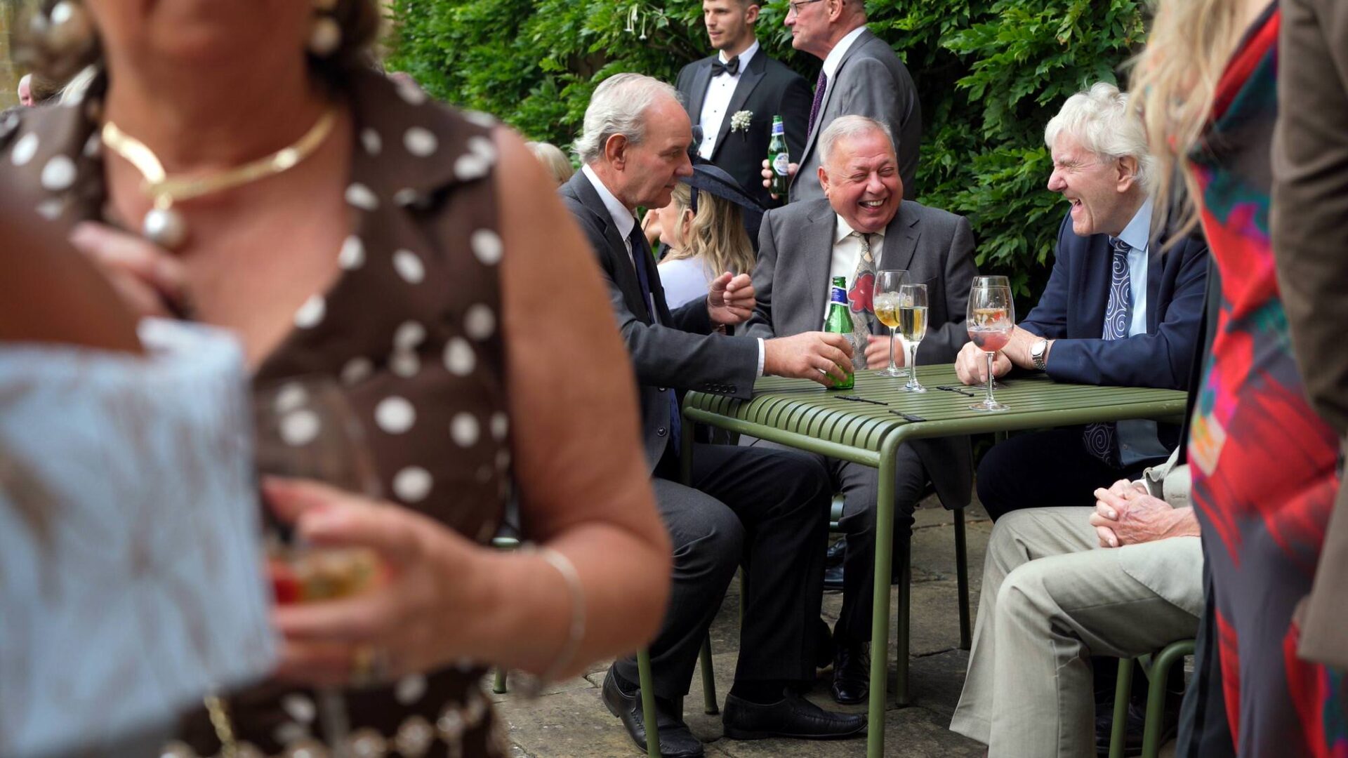 candid video still of guests laughing during wedding reception