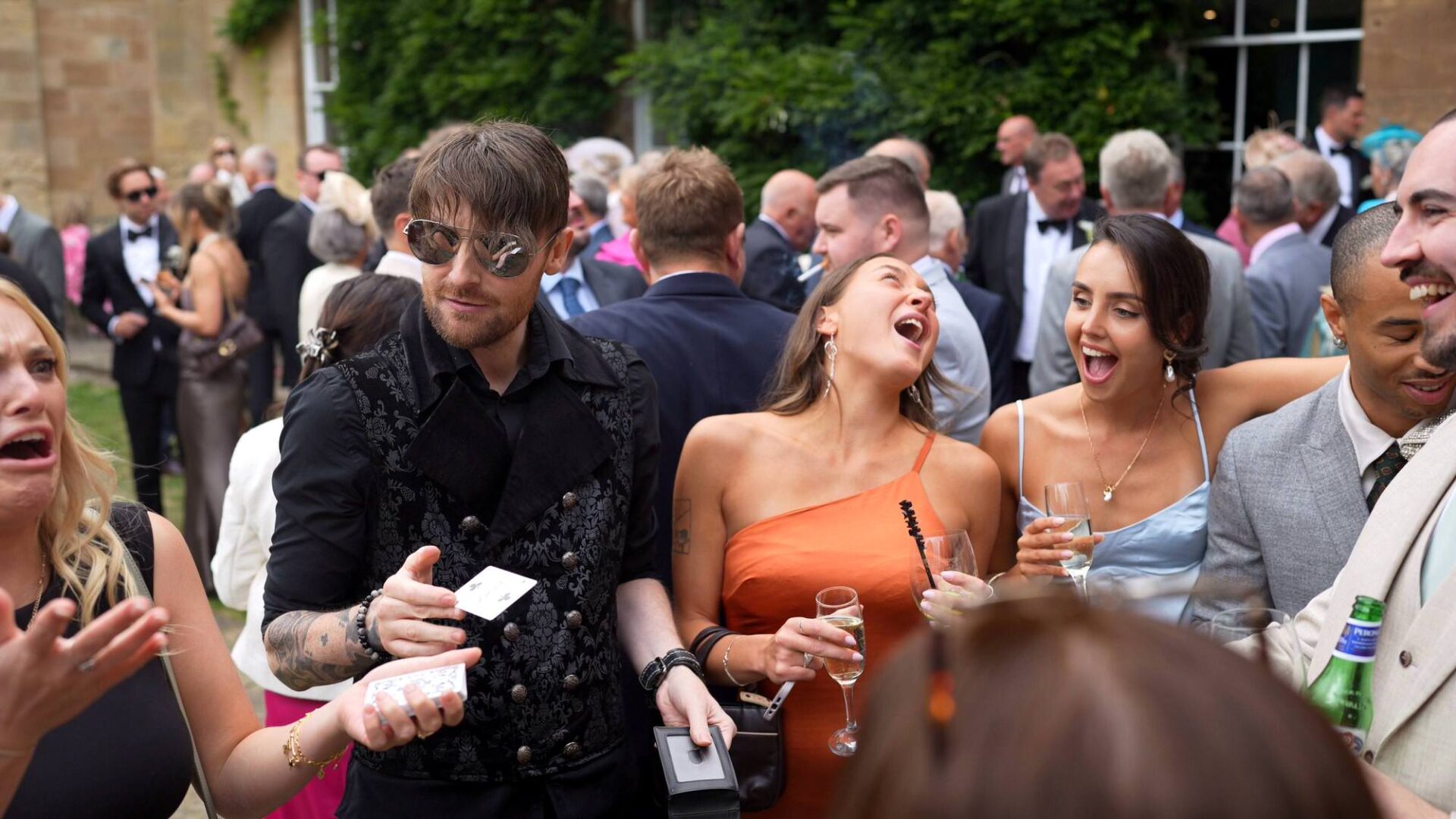 guests react in amazement to a magician during drinks reception at Rudding Park Harrogate