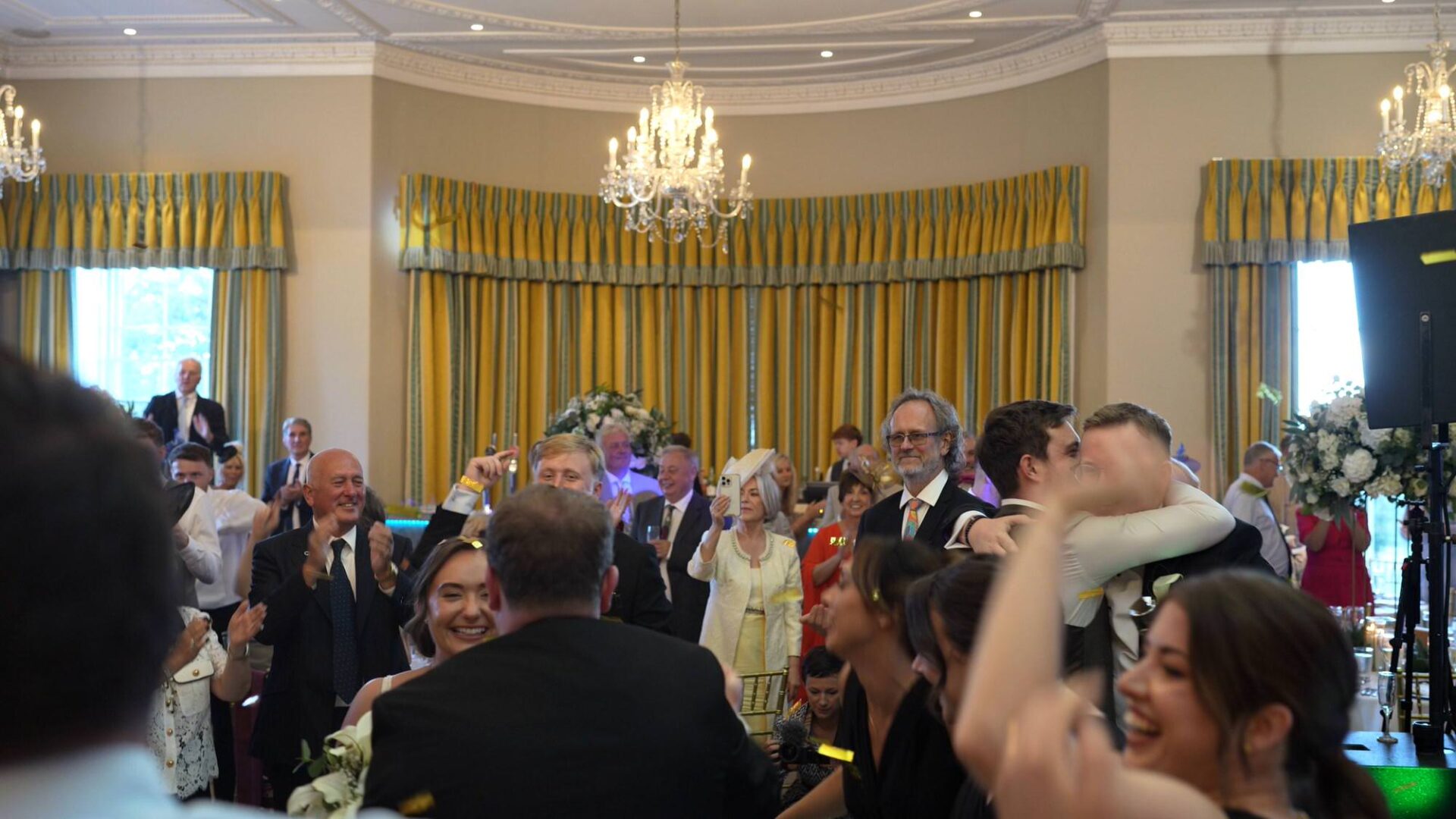 guests dance with the couple during the wedding breakfast