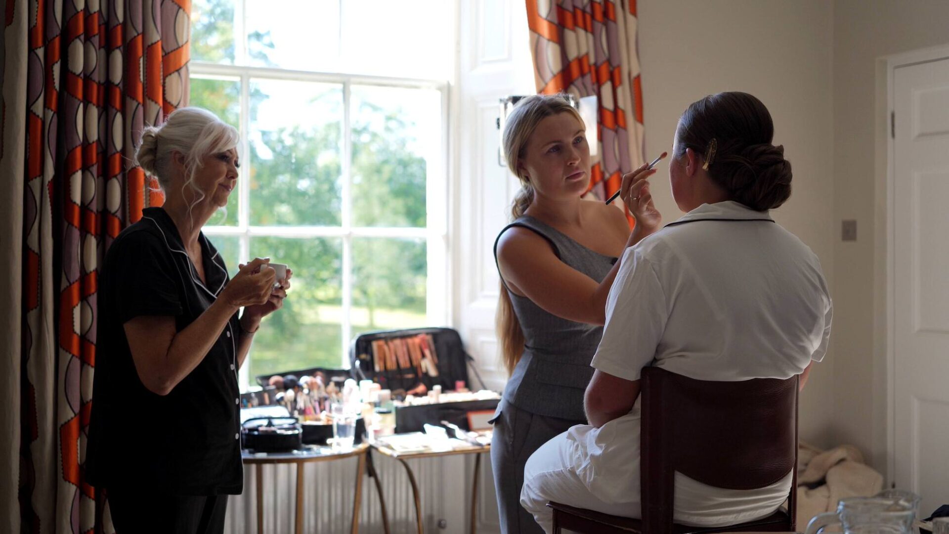 a mum smiles watching her daughter get ready at Rudding Park Harrogate